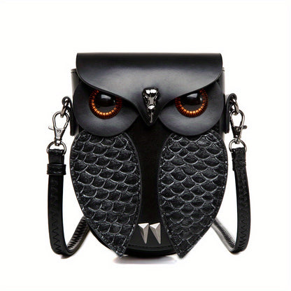 Ruth's hand-stitched owl crossbody bag in black, front view with amber glass eyes and embossed wings