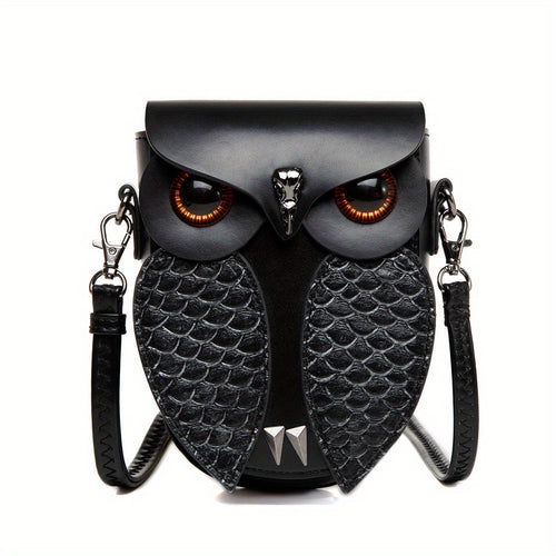 Ruth's hand-stitched owl crossbody bag in black, front view with amber glass eyes and embossed wings