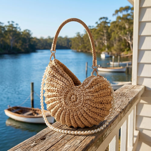 Bone White hand-woven shell handbag on a verandah rail above the Moyne River