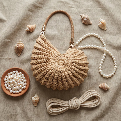Shell handbag flat lay with freshwater pearls, shells and cotton rope