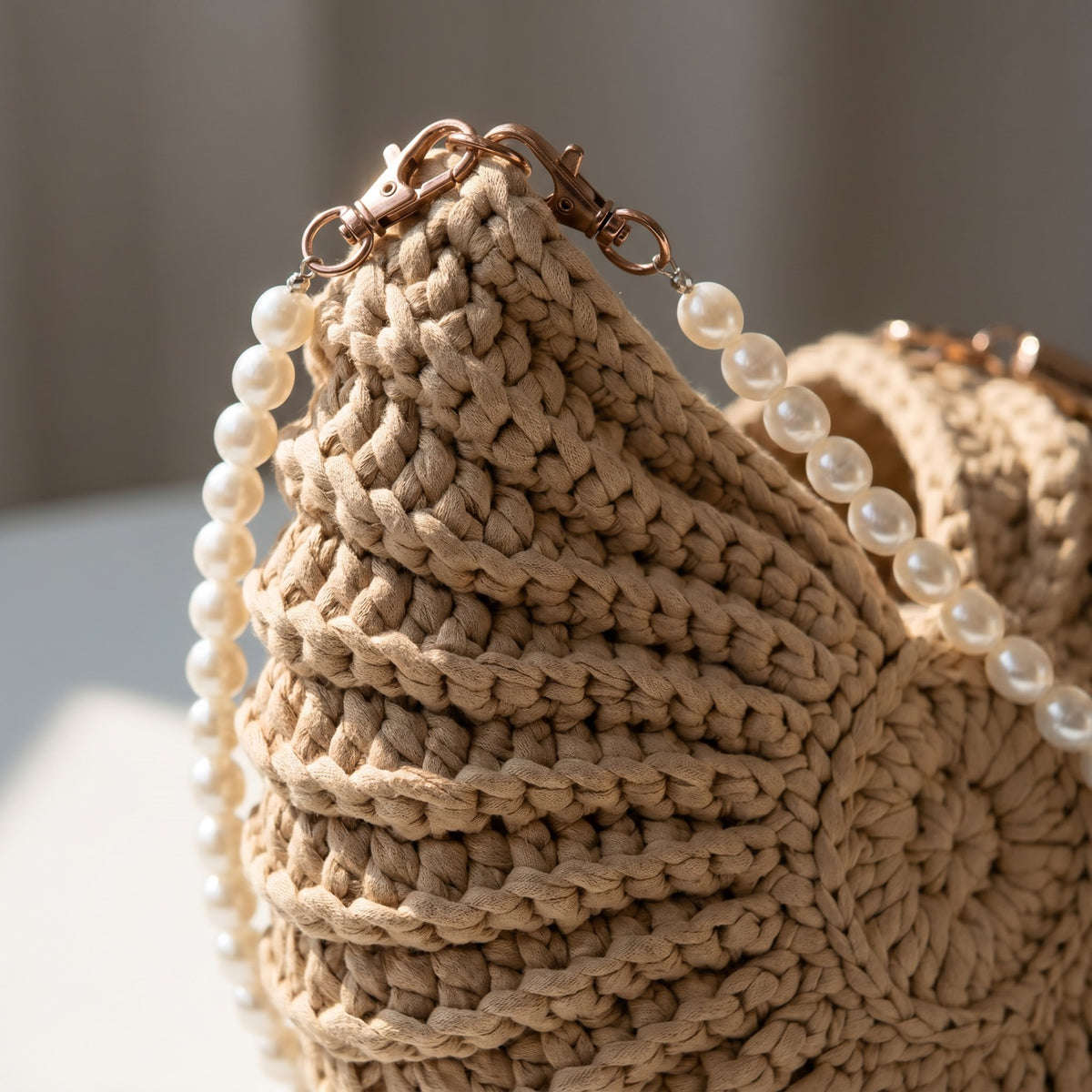 Close-up of the bronze clips and hand-strung freshwater pearl strap