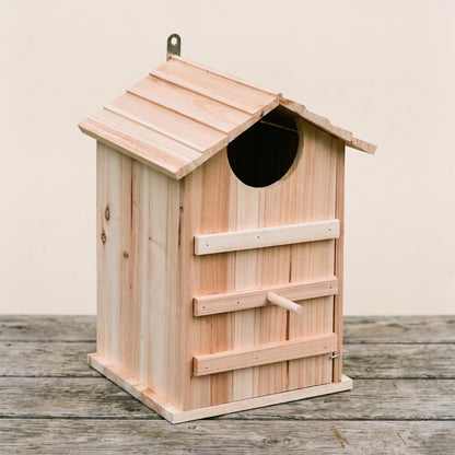 Col's hand-built untreated pine owl box, three-quarter studio view on weathered timber