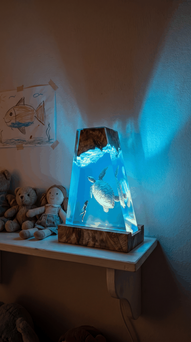 The turtle lamp glowing on a shelf in a child's bedroom