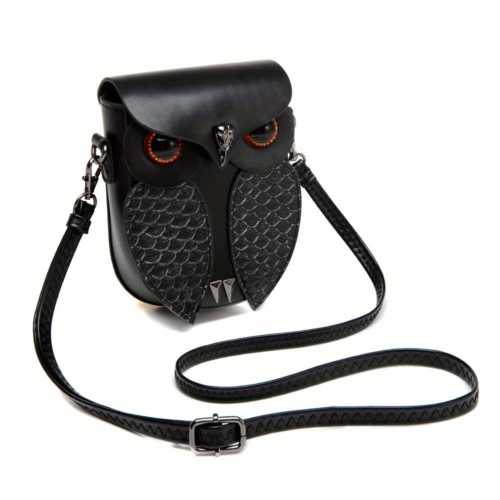 Owl bag shown with its adjustable braided crossbody strap laid out