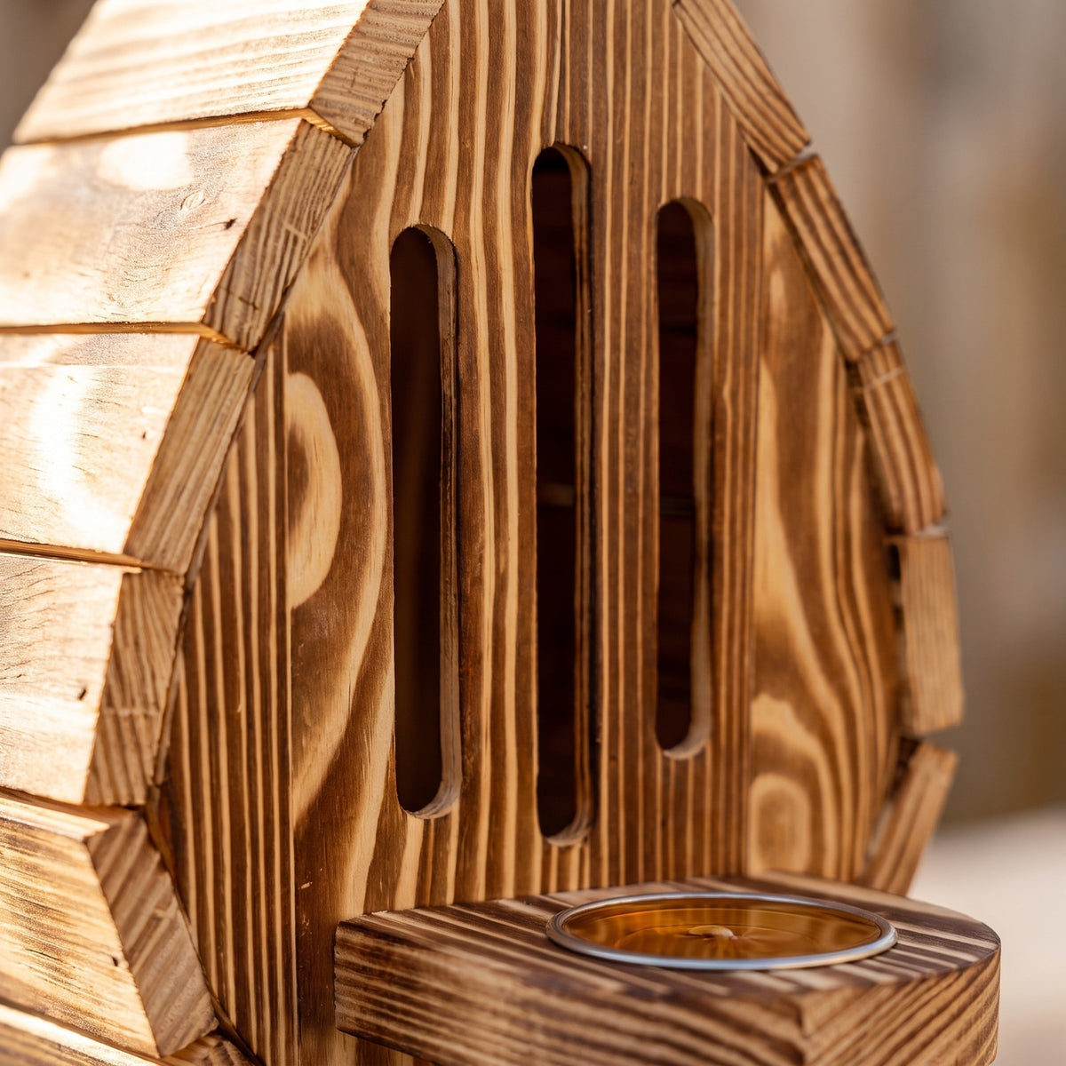 Close-up of the entry slots and scorched timber grain