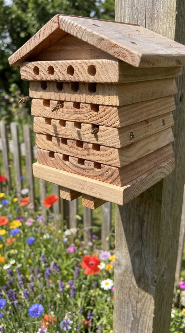 Bee hotel on a tall garden post