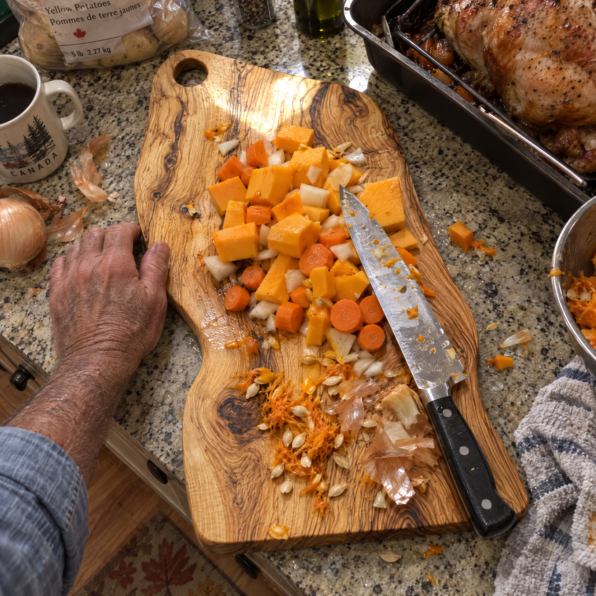 Squash and carrots for Thanksgiving dinner chopped on the board