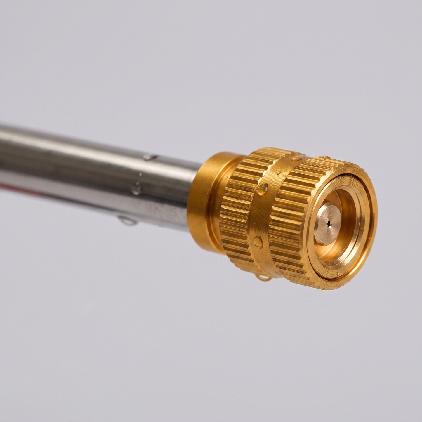 Close-up of the adjustable brass nozzle head on the chrome lance