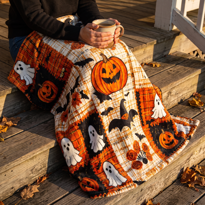 Woman wrapped in the Halloween blanket on porch steps with a mug of coffee