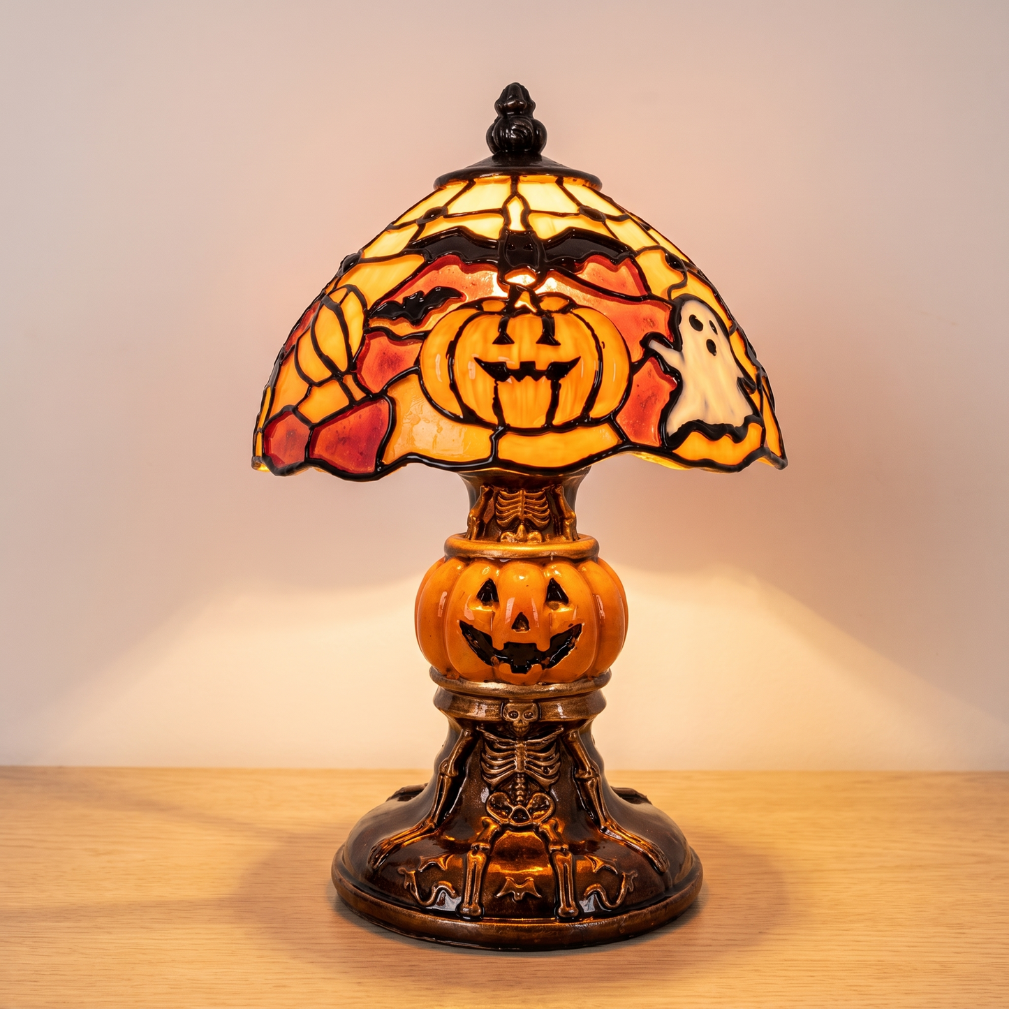 Donna's Handmade Halloween Stained-Glass Lamp, lit, on pale oak