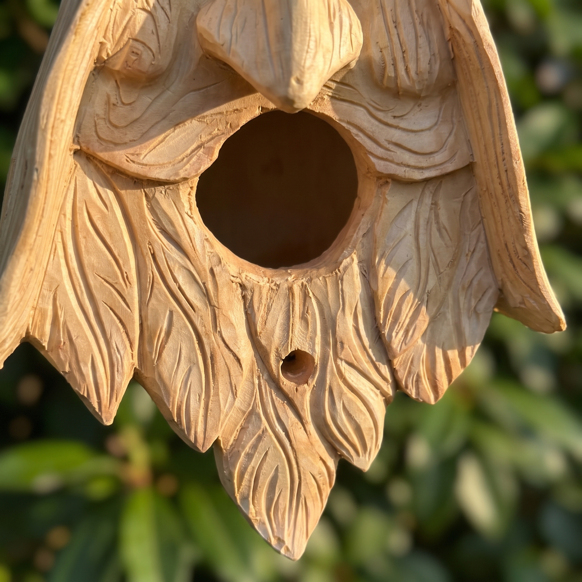 Close-up of the carved leaf beard, entrance and drain hole
