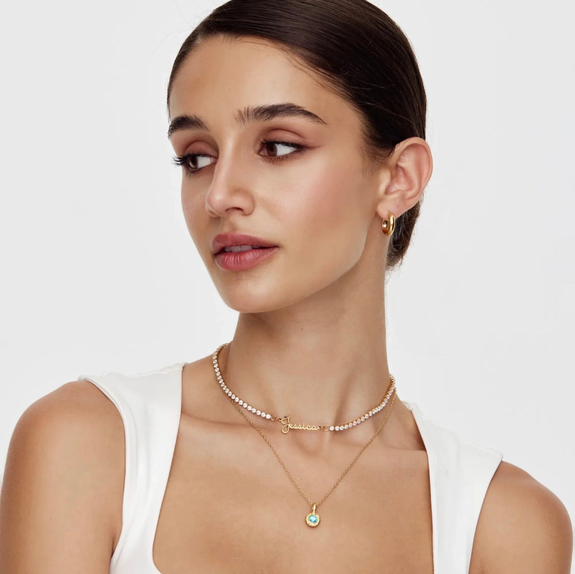The Celeste — name in golden script on pearl choker, close-up