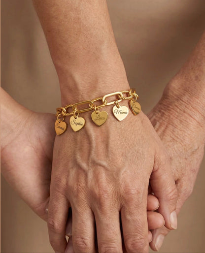 The Florence charm bracelet worn — hearts with engraved names