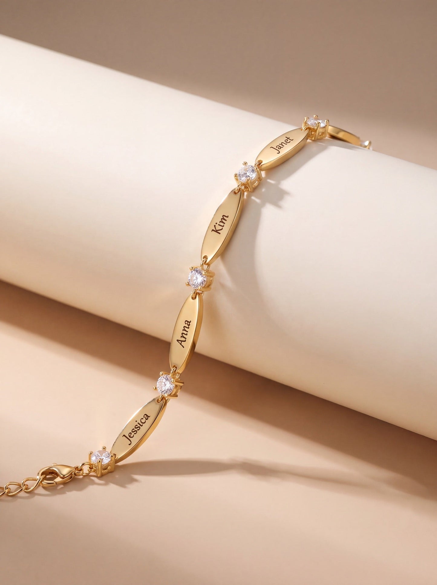The Luna personalized name bracelet in gold on marble