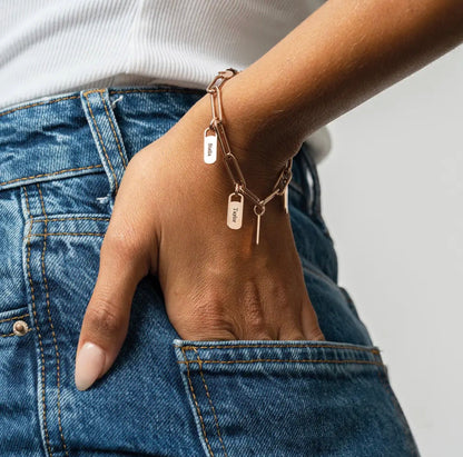 The Scarlett — gold paperclip chain with name tags, close-up