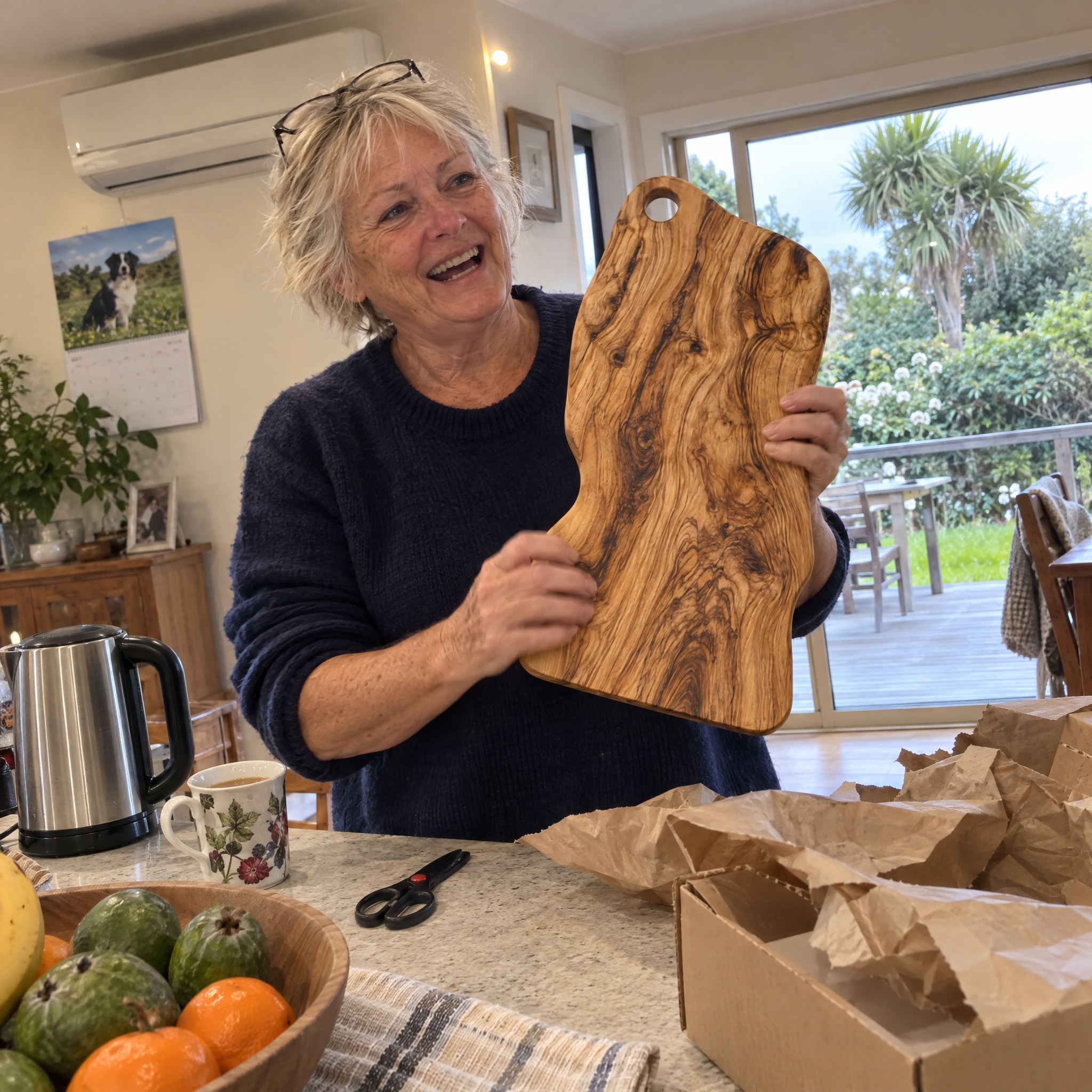 Customer unboxing the olive wood board in her kitchen