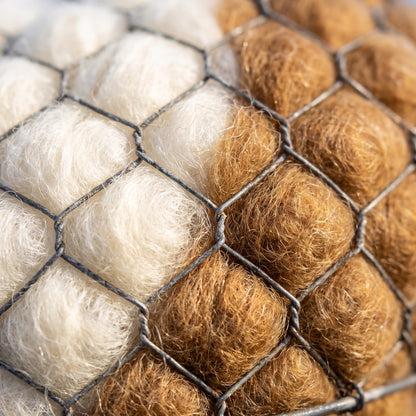 Close-up of the wire mesh and raw undyed alpaca fleece
