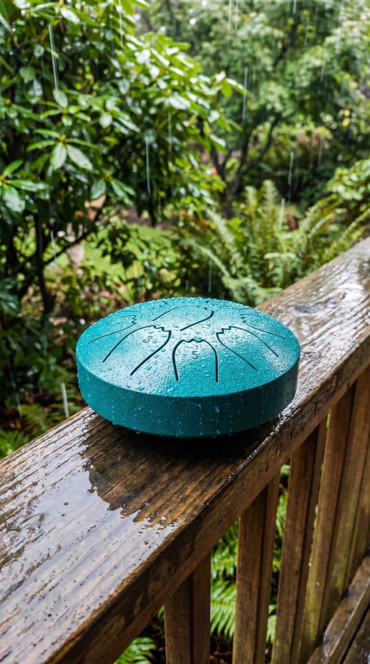 Rain drum on a wooden deck railing