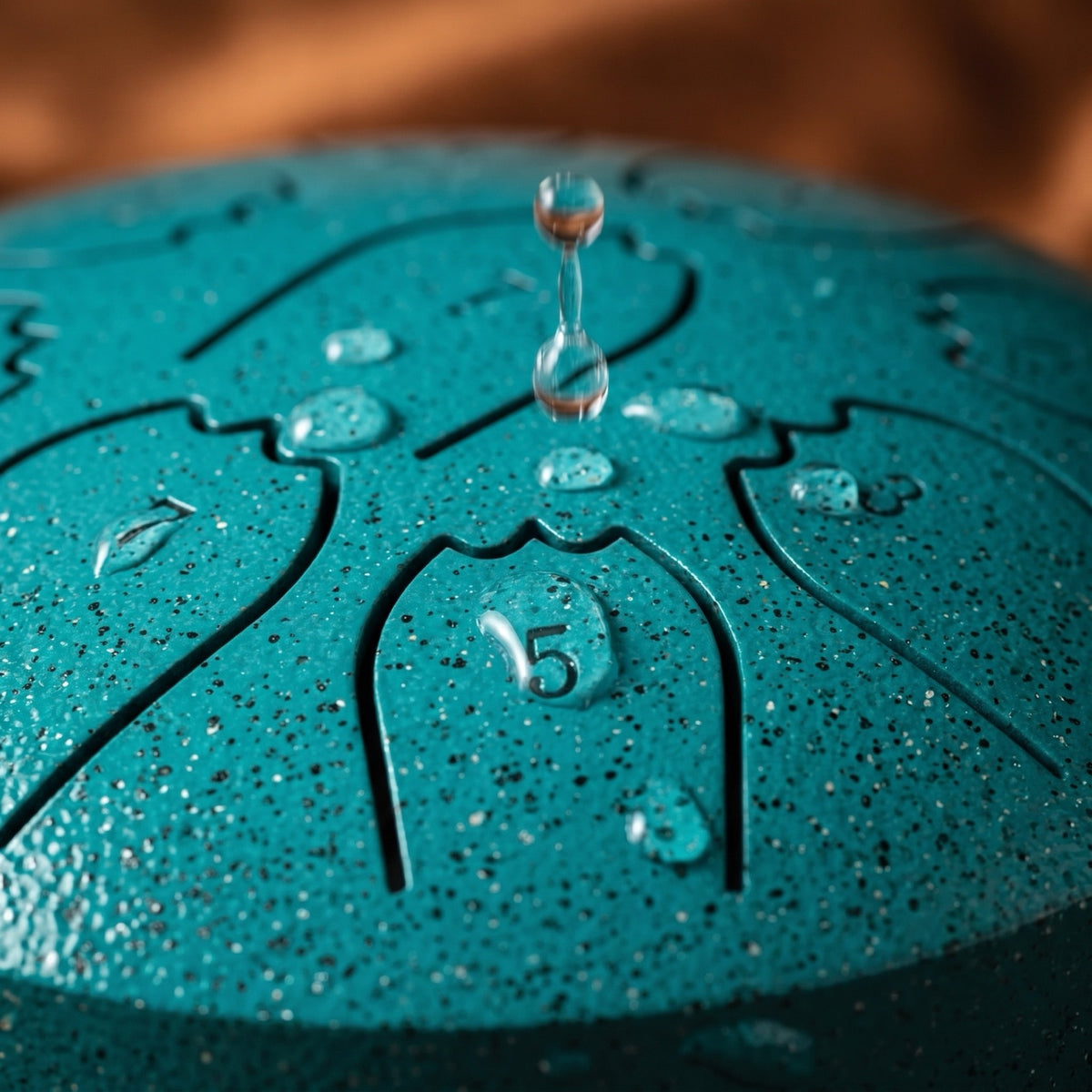 Macro shot of a raindrop on the tuned steel tongues