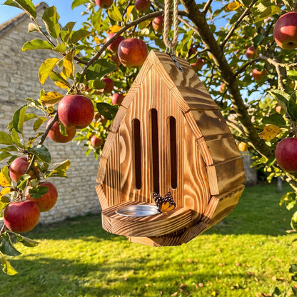 Wendy's handmade teardrop butterfly house hanging in an apple tree